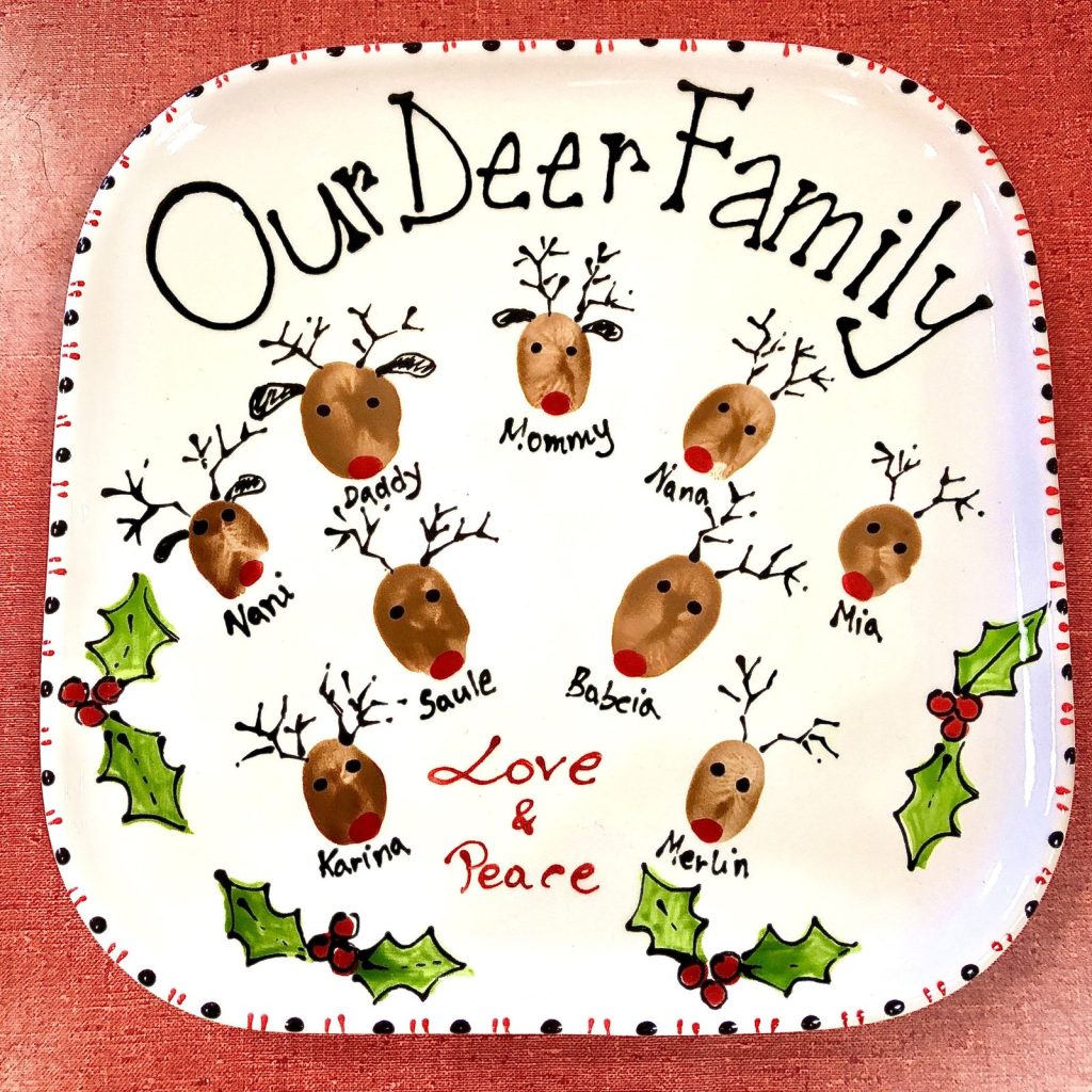 Christmas plate with fingerprint reindeer for each family member, holly and the words Our Deer Family