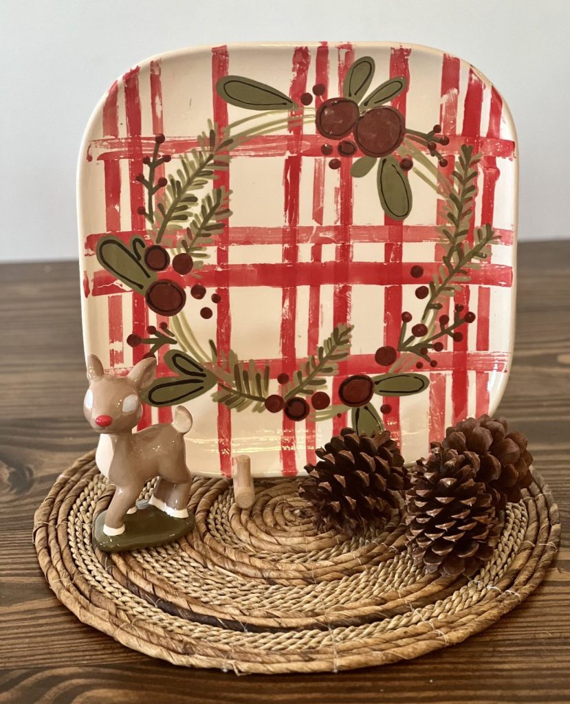Square Christmas plate painted with red plaid and an evergreen and berry wreath
