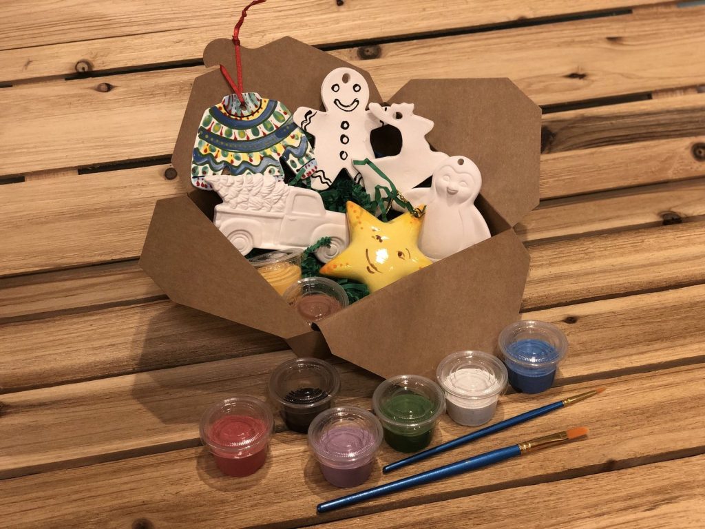 Paint-at-home kit with bisque gingerbread and star ornaments, paint pots and brushes in a kraft box