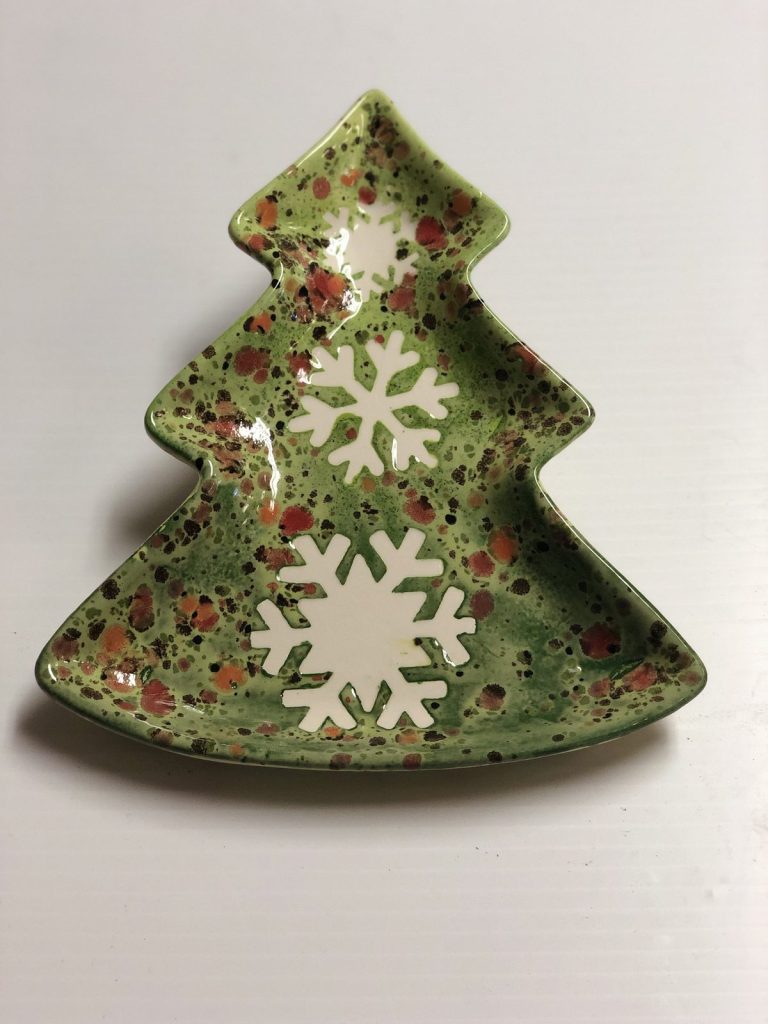 Hand-painted Christmas tree-shaped dish in speckled green with large white snowflakes
