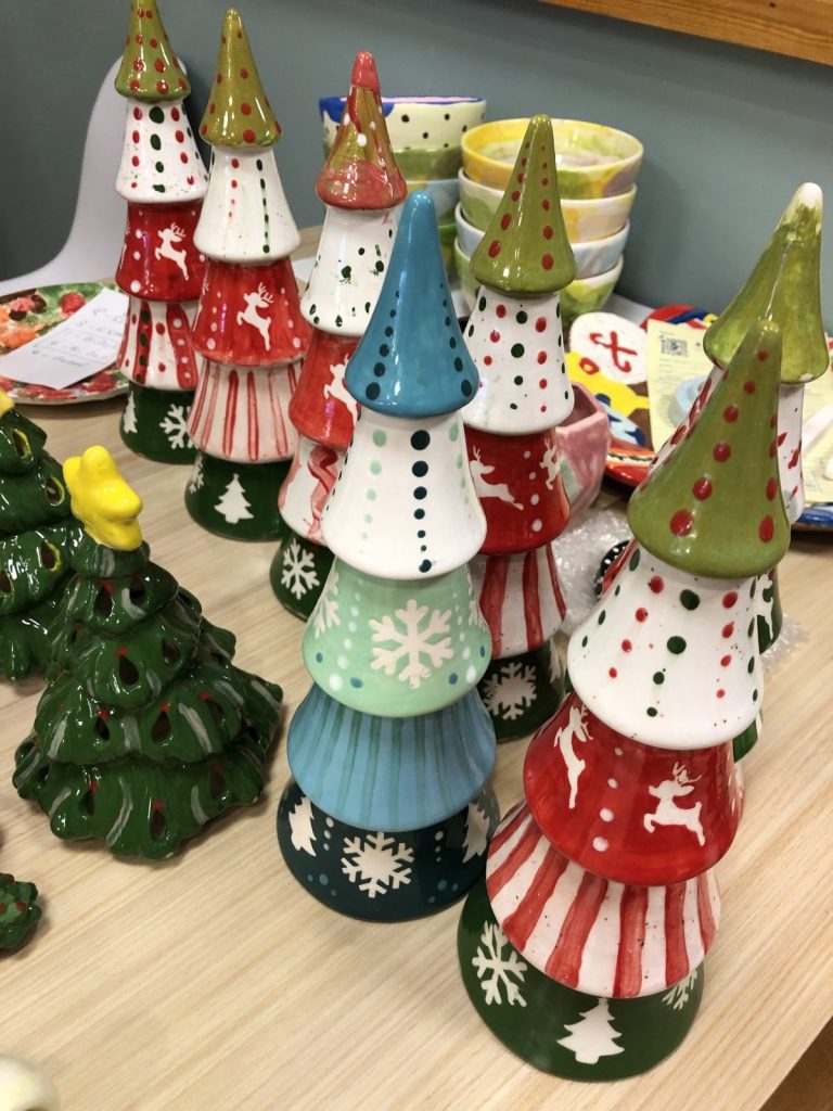 Hand-painted stacked cone Christmas trees in red, green and white with snowflakes and reindeer