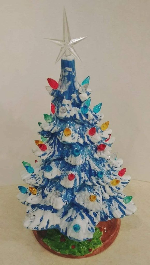 Hand-painted blue and white frosted ceramic Christmas tree with colorful bulbs and a clear star