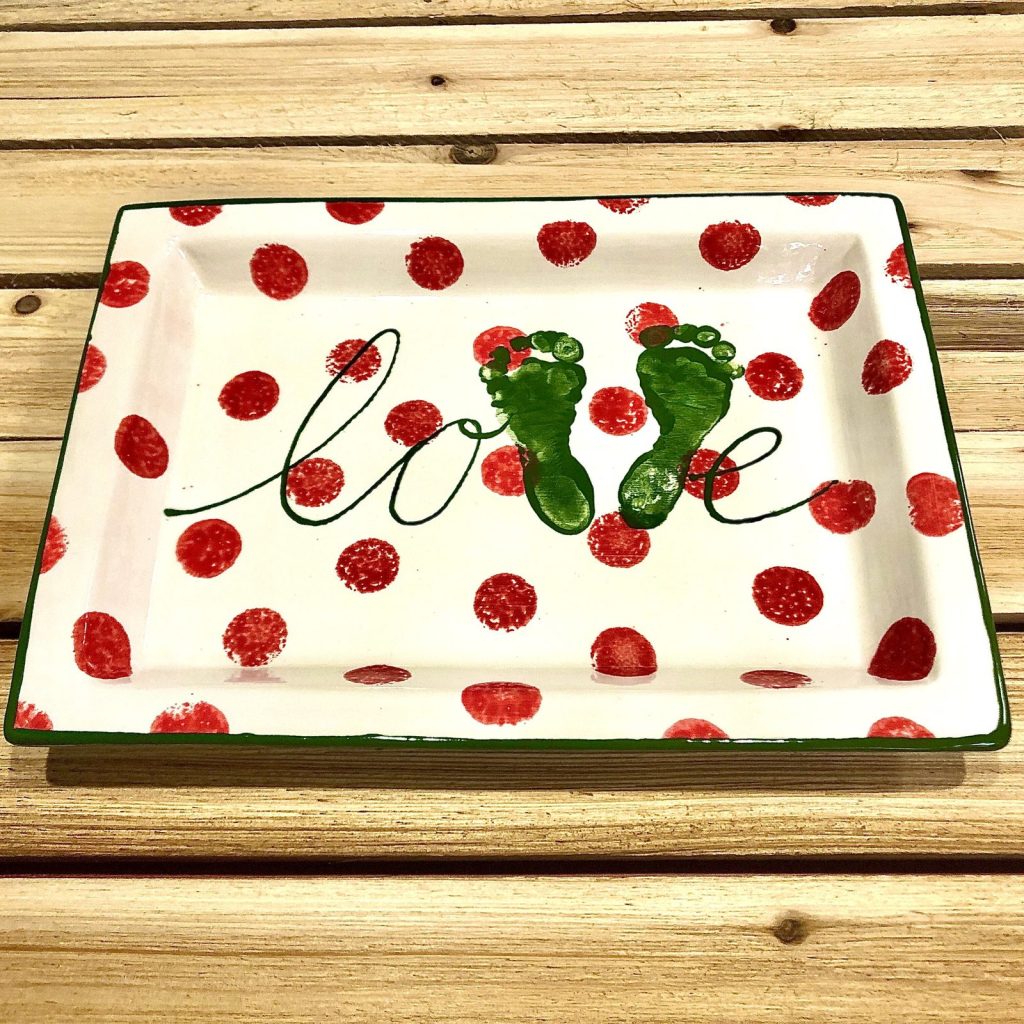 Hand-painted rectangular platter with green baby footprints and love script on red polka dots