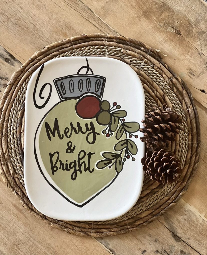 Hand-painted ornament-shaped platter in sage green with Merry & Bright lettering and greenery