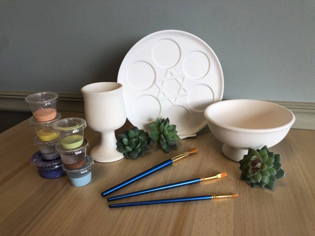 Passover paint kit with an unpainted seder plate, kiddush cup and bowl, paints and brushes