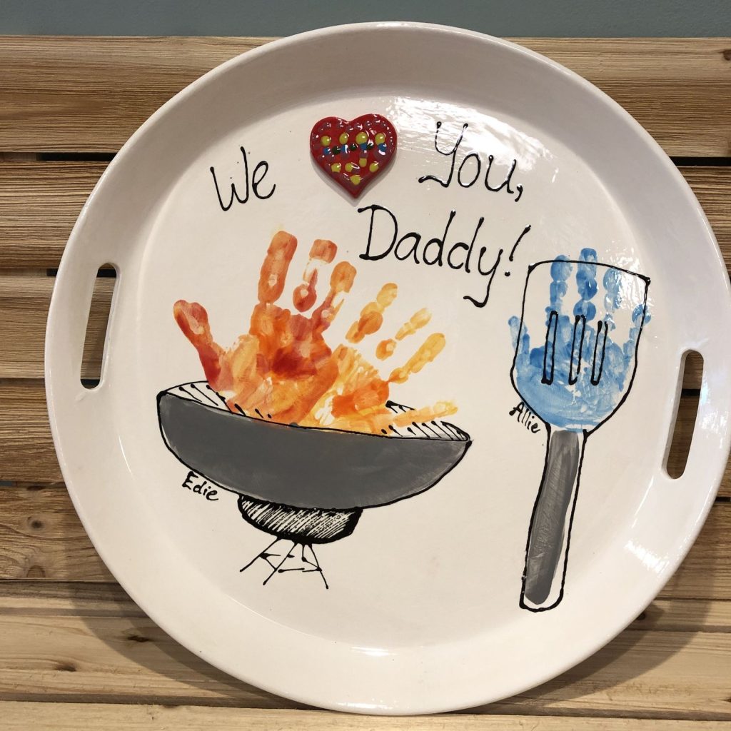 Round handled tray with orange handprint grill flames and blue handprint spatula for Daddy