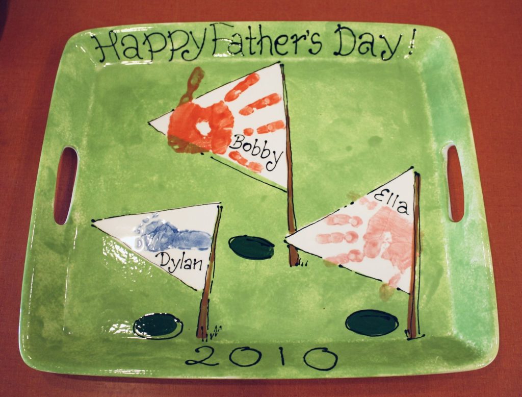 Hand-painted green Happy Father's Day tray with handprint golf flags on a putting green, dated 2010