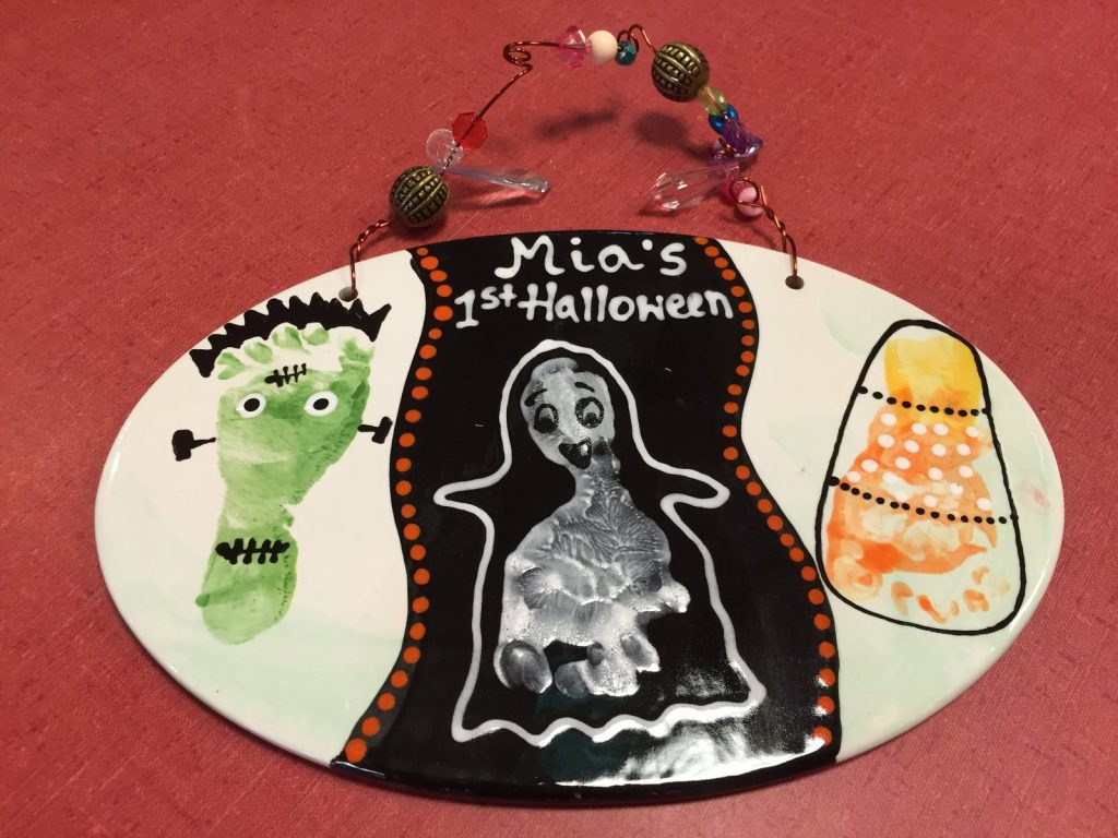 Hand-painted oval first Halloween plaque with a footprint Frankenstein, ghost and candy corn