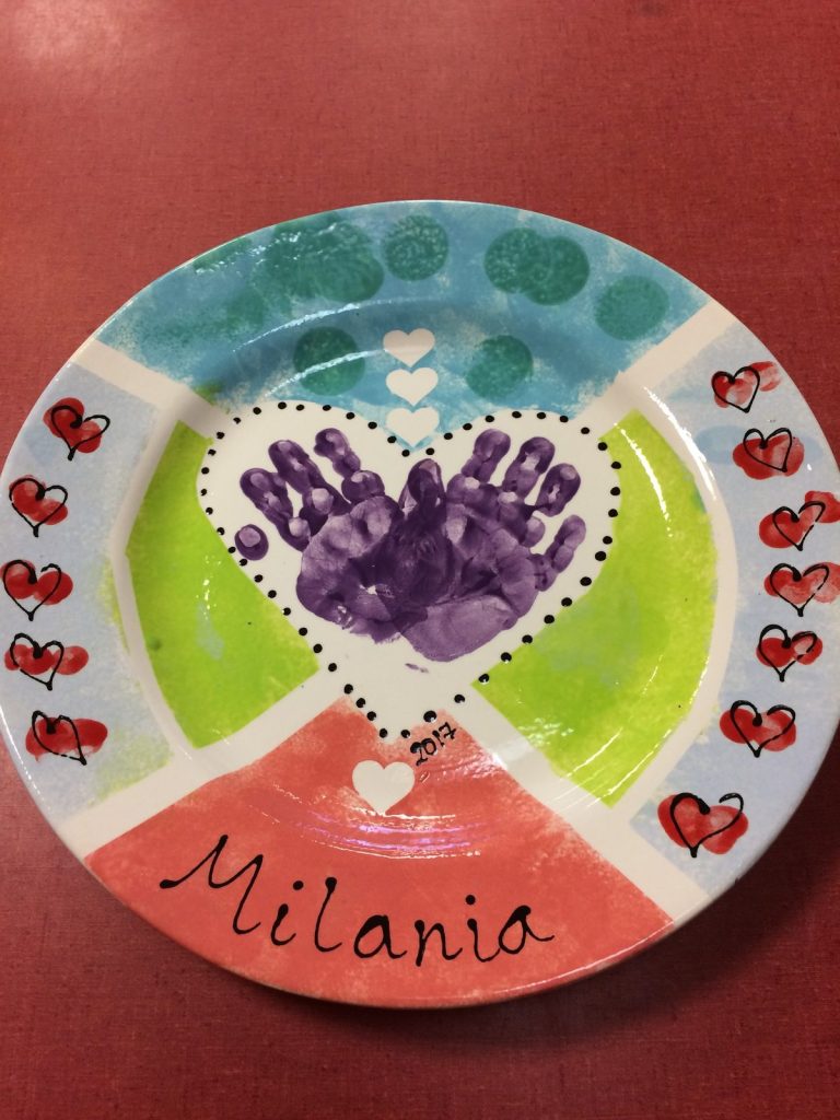 Hand-painted plate with purple handprints in a heart over lime, aqua and coral panels