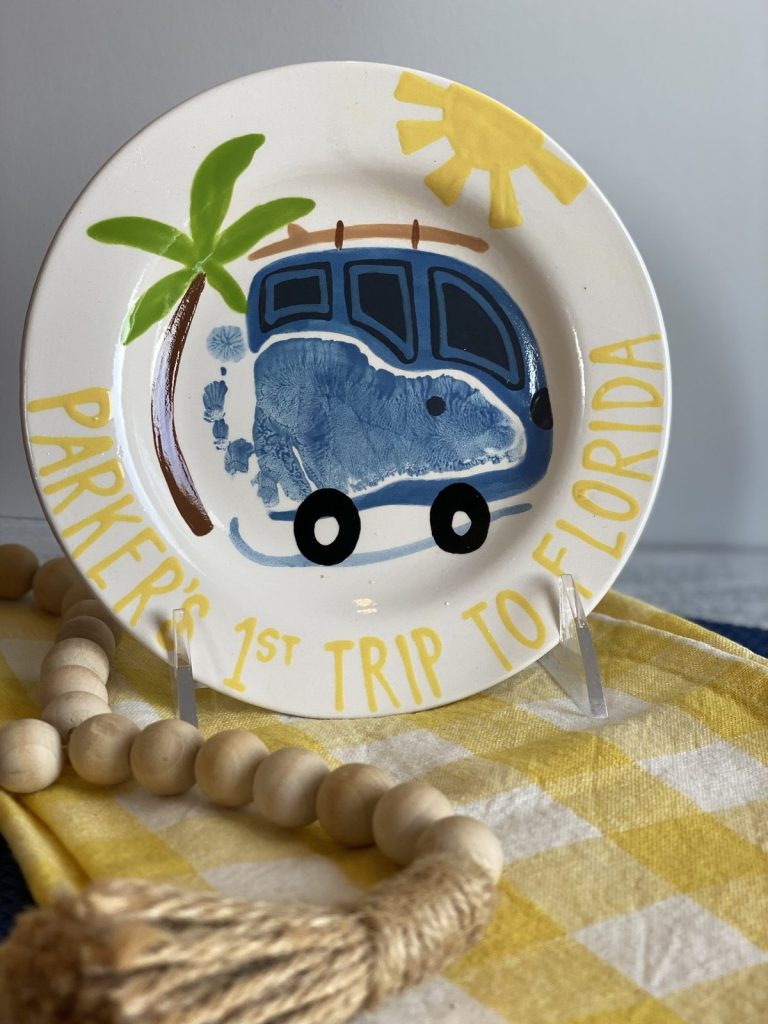 Hand-painted first trip to Florida plate with a blue footprint van, palm tree and yellow sun