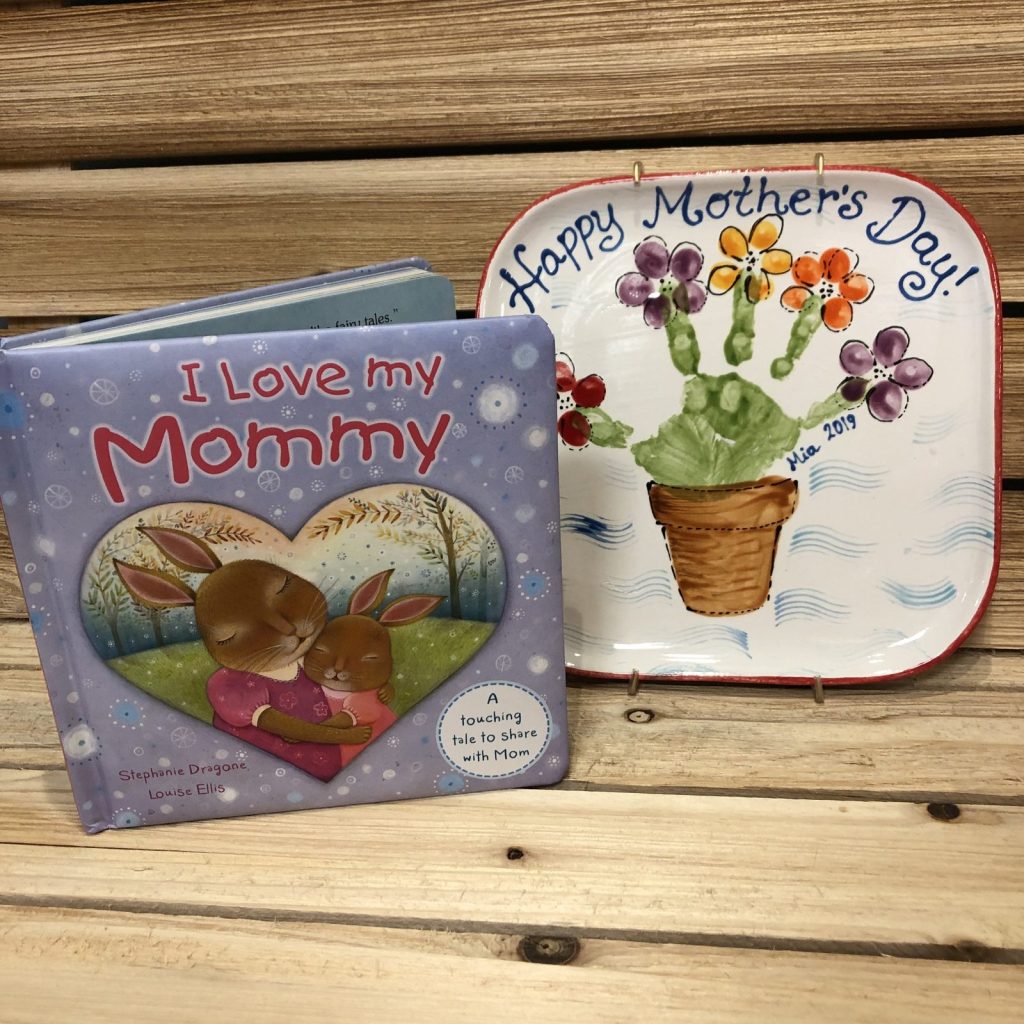 Hand-painted Happy Mother's Day plate with handprint flowers in a pot beside an I Love my Mommy book