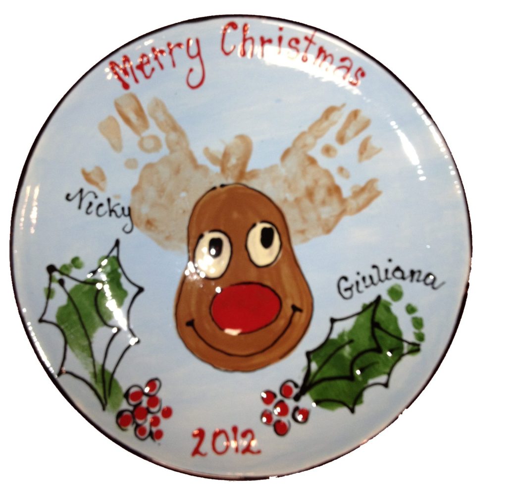 Hand-painted Merry Christmas plate with a handprint antler reindeer and holly, dated 2012