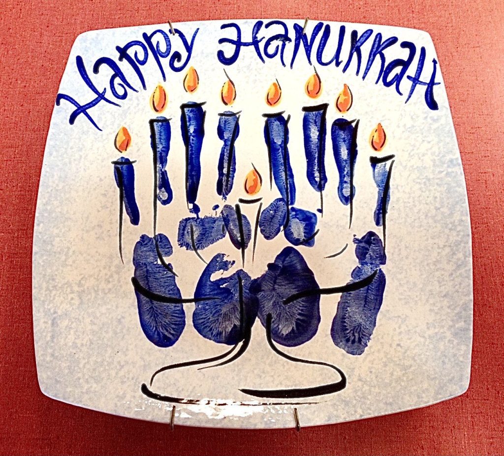 Hand-painted Happy Hanukkah platter with a blue handprint menorah and orange candle flames