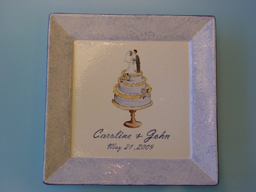 Square wedding plate with a painted cake topper couple and a pale blue speckled border