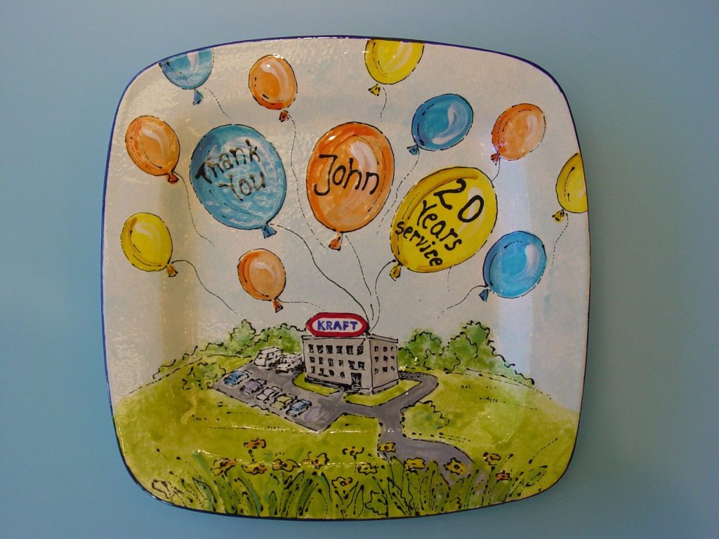 Square retirement-style platter with colorful balloons floating above an office building, 20 years of service