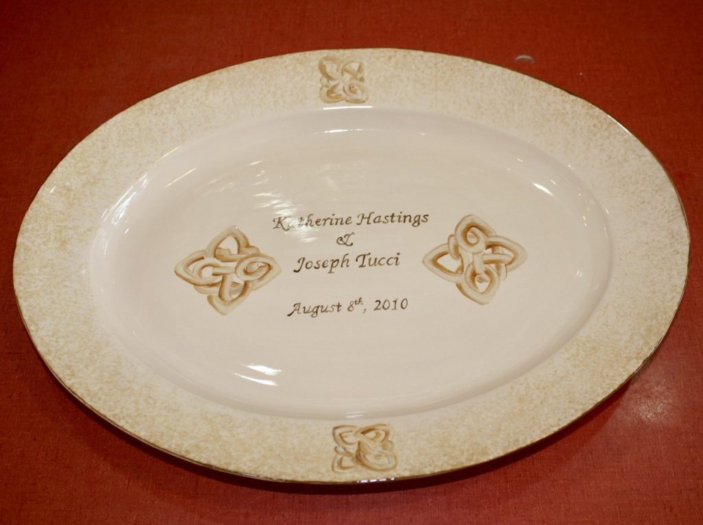 Hand-painted oval wedding platter with a cream speckled rim, scroll motifs and a 2010 date