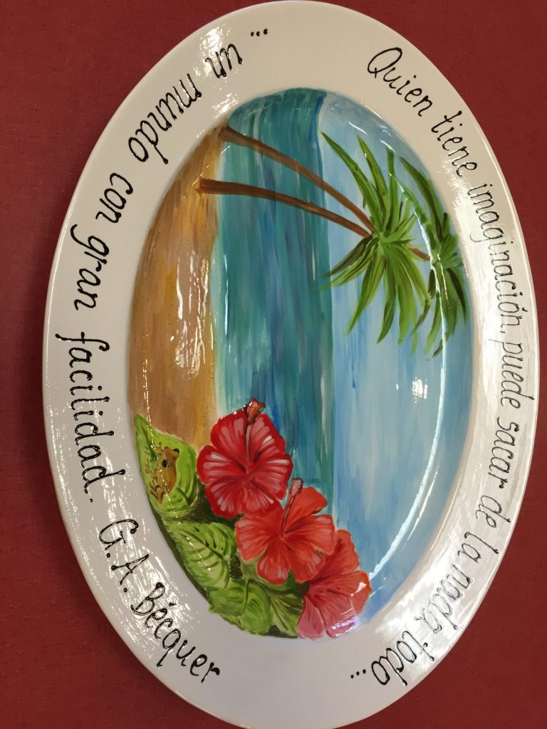Hand-painted oval platter of a tropical beach with palms, red hibiscus and a Spanish quote