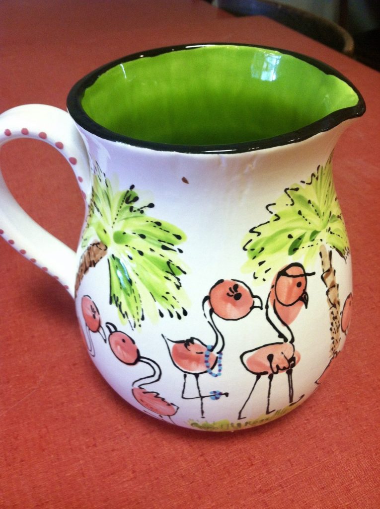 Hand-painted pitcher with fingerprint flamingos and palm trees and a lime green interior