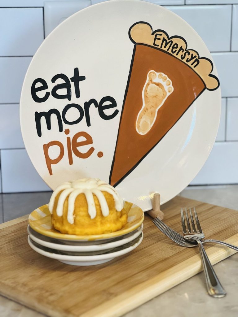 Hand-painted Thanksgiving plate reading eat more pie with a brown footprint pumpkin pie slice