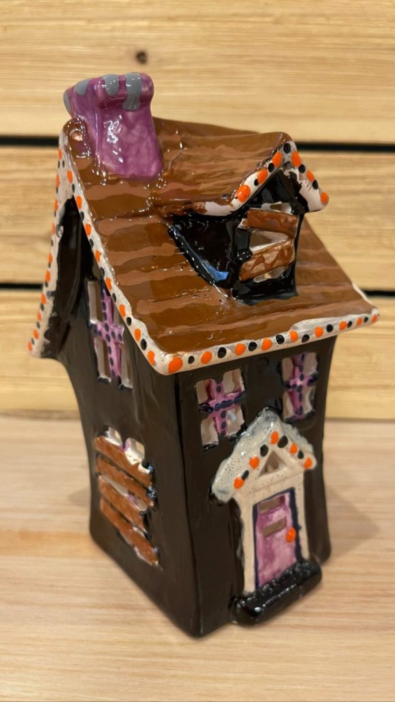 Hand-painted haunted house lantern with a brown shingled roof, purple chimney, and dark walls