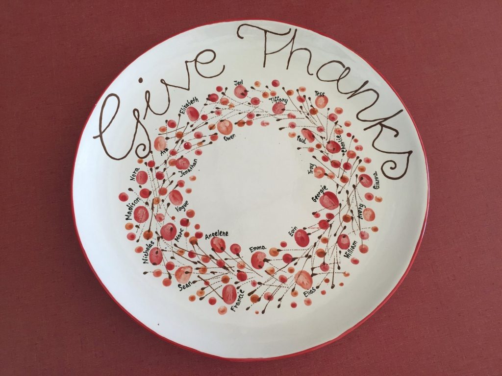 Hand-painted round plate reading Give Thanks with a wreath of red fingerprint berries