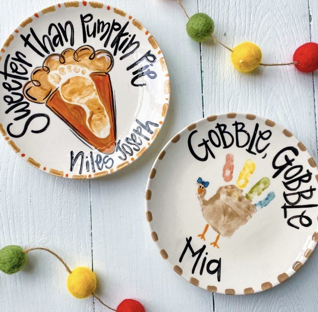 Two hand-painted keepsake plates, a Sweeter Than Pumpkin Pie handprint and a Gobble Gobble handprint turkey