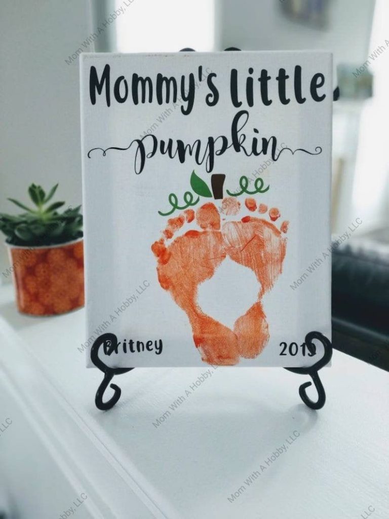 Hand-painted tile reading Mommy's Little Pumpkin with orange footprints forming a pumpkin