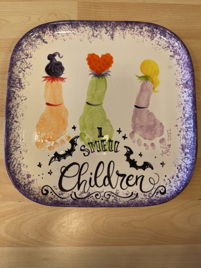 Hand-painted square plate of three footprint witches with I Smell Children lettering and bats