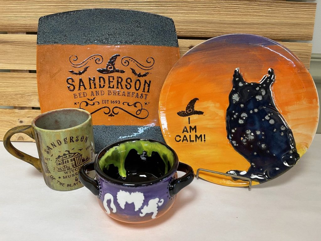 Hand-painted Hocus Pocus set with a Sanderson Bed and Breakfast platter, black cat plate, mug, and cauldron bowl