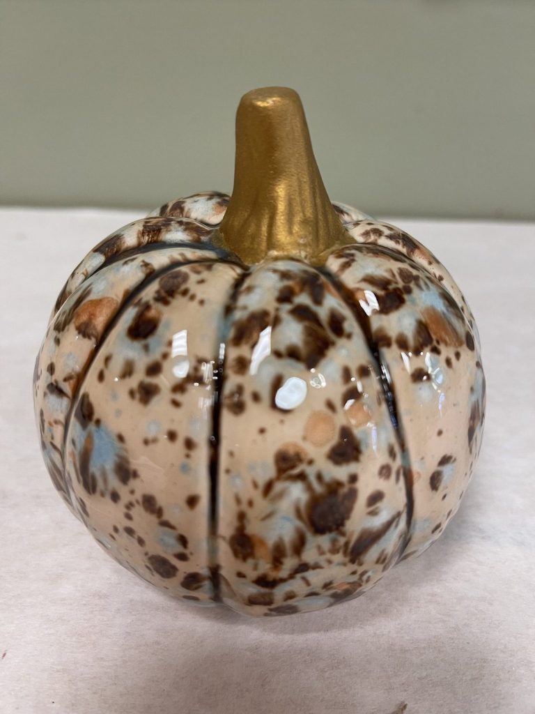 Hand-painted cream pumpkin with brown and blue speckles and a gold stem