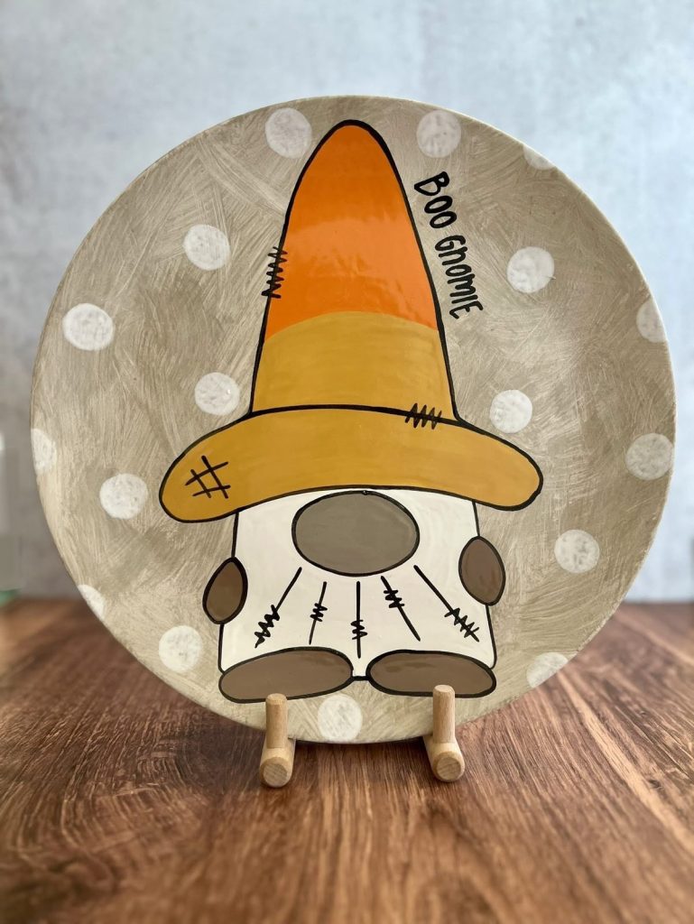 Hand-painted plate of a gnome in a candy corn hat reading Boo Gnome