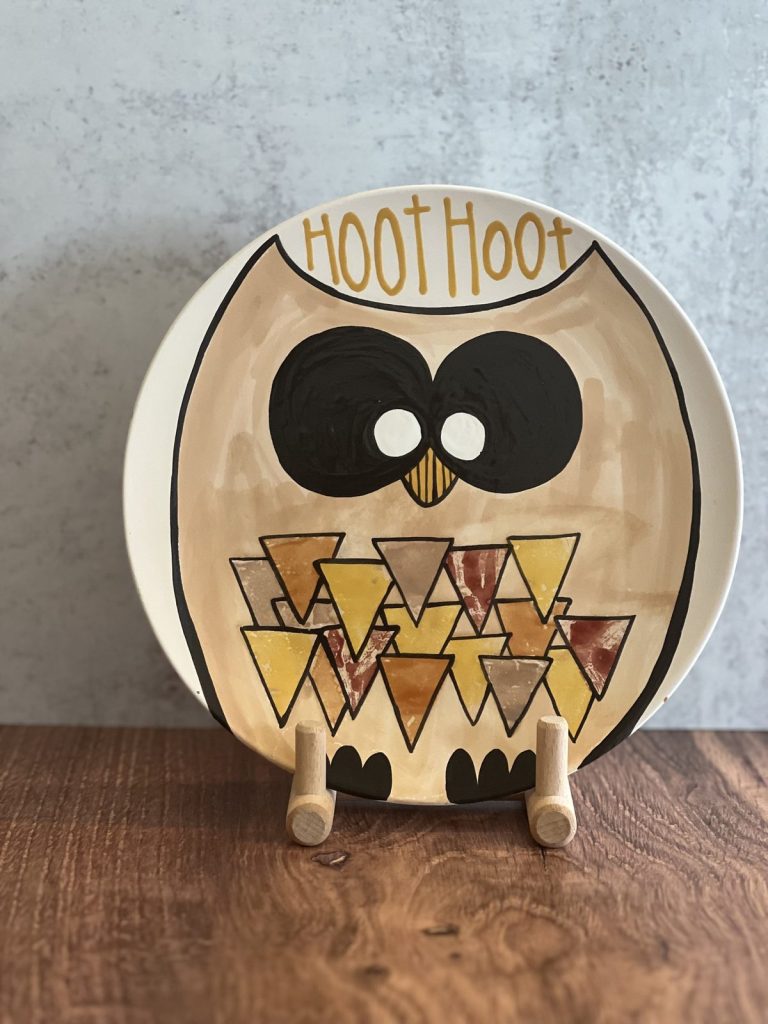 Hand-painted plate of an owl with a Hoot Hoot banner and a multicolored triangle-pattern body