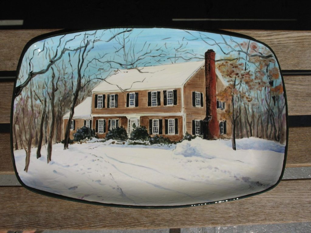 Hand-painted rectangular platter of a brick colonial house in snow with a tall red chimney