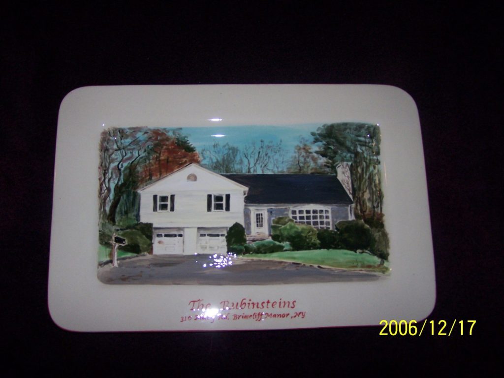 Hand-painted rectangular platter of a white split-level house with a two-car garage and autumn trees