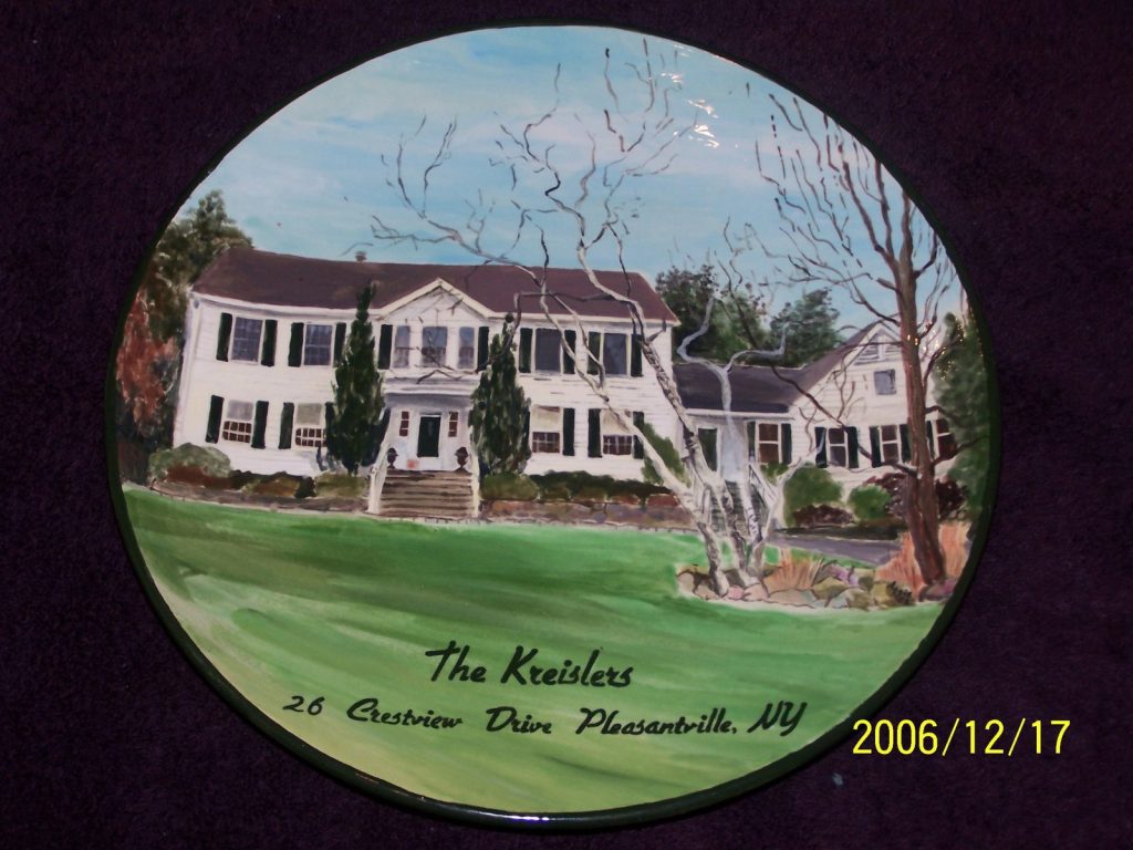 Hand-painted round platter of a white colonial house with black shutters and bare trees