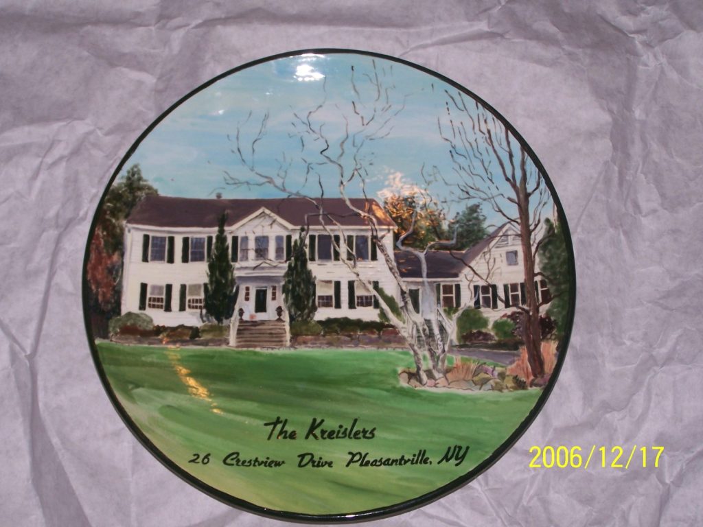 Hand-painted round platter of a white colonial house with black shutters on a lavender backdrop