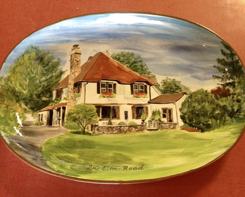 Hand-painted oval platter of a cream Tudor-style house with a brown roof and stone chimney