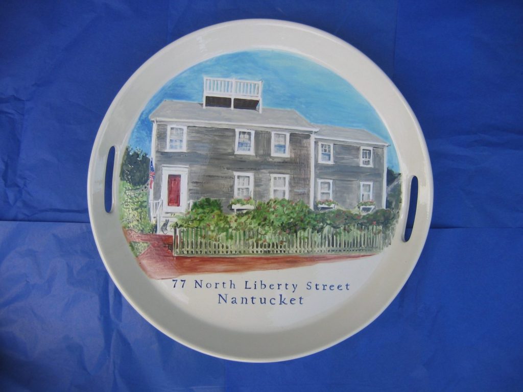 Hand-painted round handled tray of a gray shingled Nantucket house with a picket fence