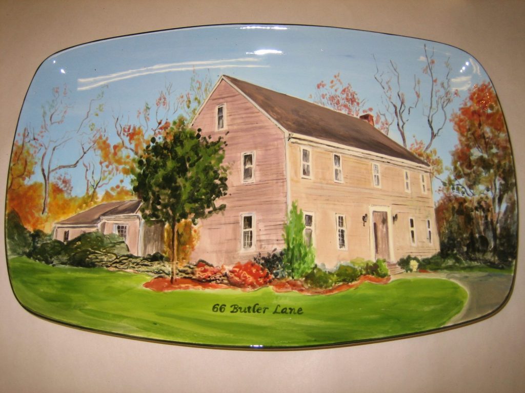 Hand-painted rectangular platter of a pink colonial house with autumn trees and flower beds