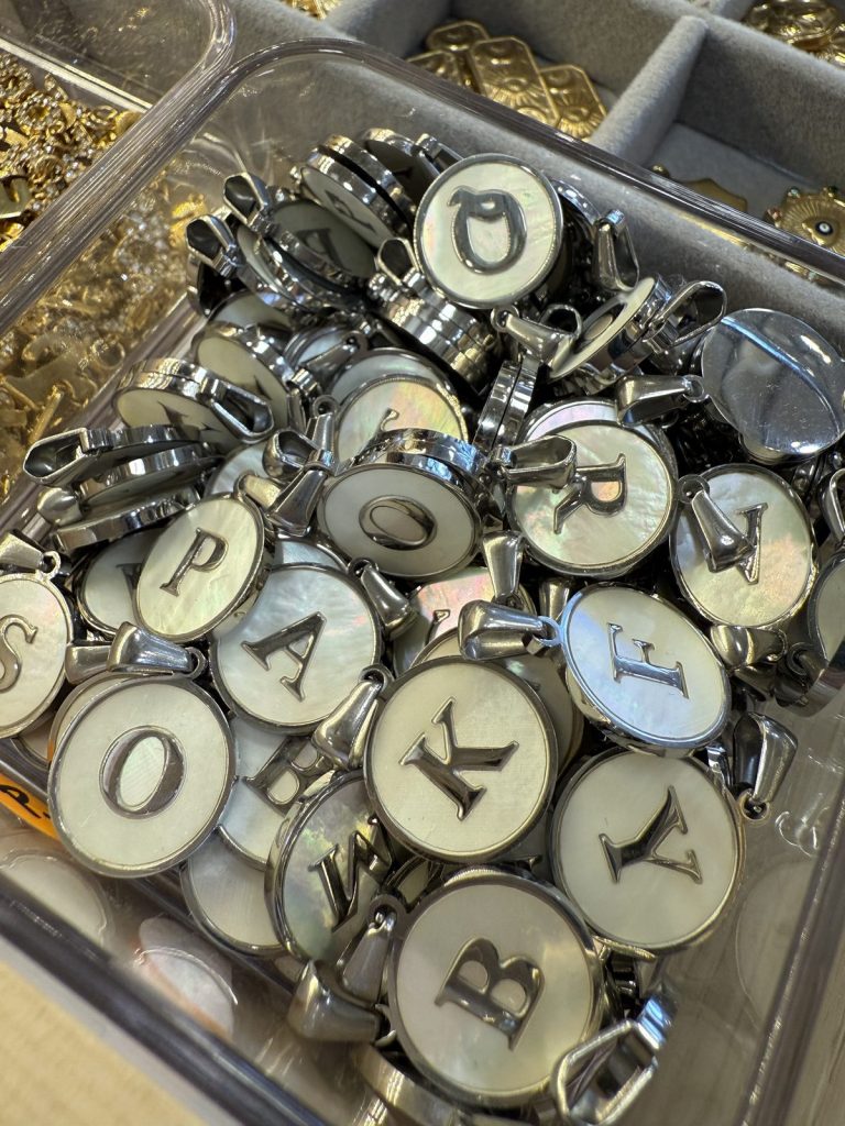 Silver initial charms with mother-of-pearl letters