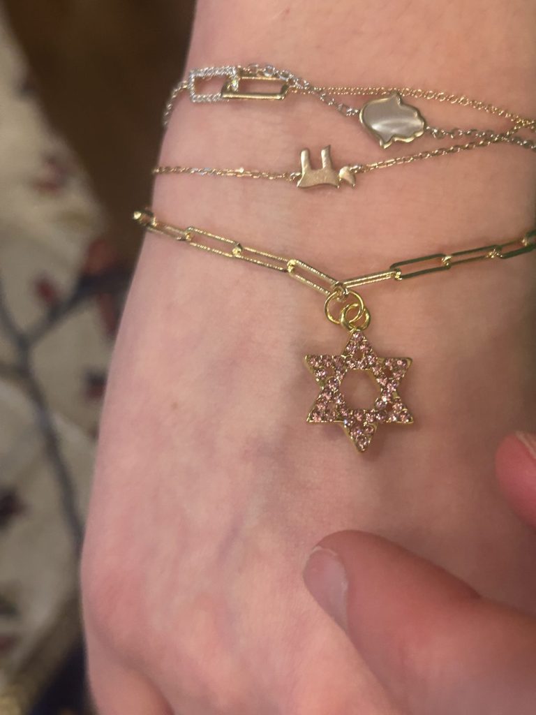 Layered bracelets with a jeweled Star of David charm