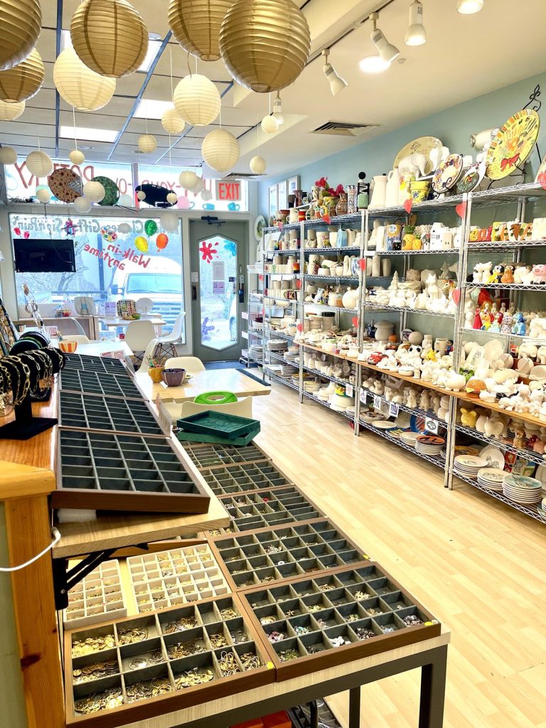 The Charm Bar counter inside our Briarcliff Manor studio, with trays of charms