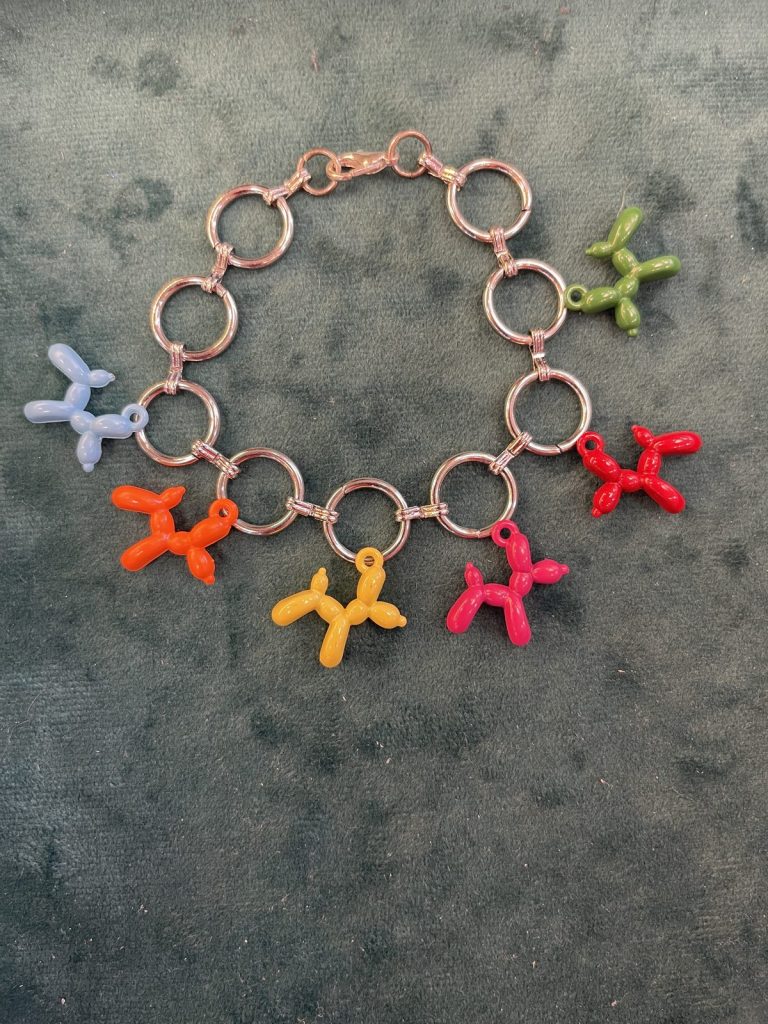 Rose-gold bracelet with colorful balloon-dog charms