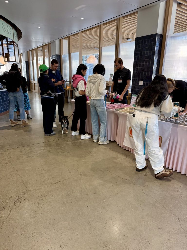 Guests lined up along the Mobile Charm Bar at a corporate event