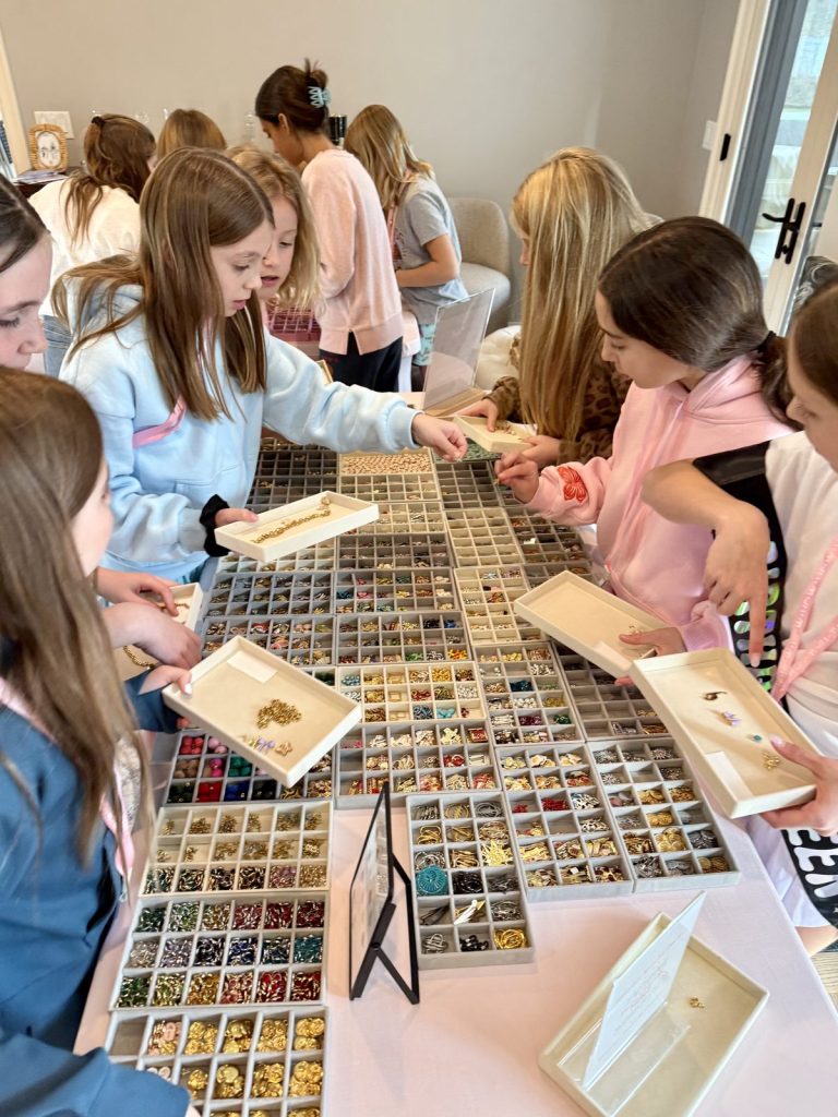 Kids comparing charms on their trays at a birthday party