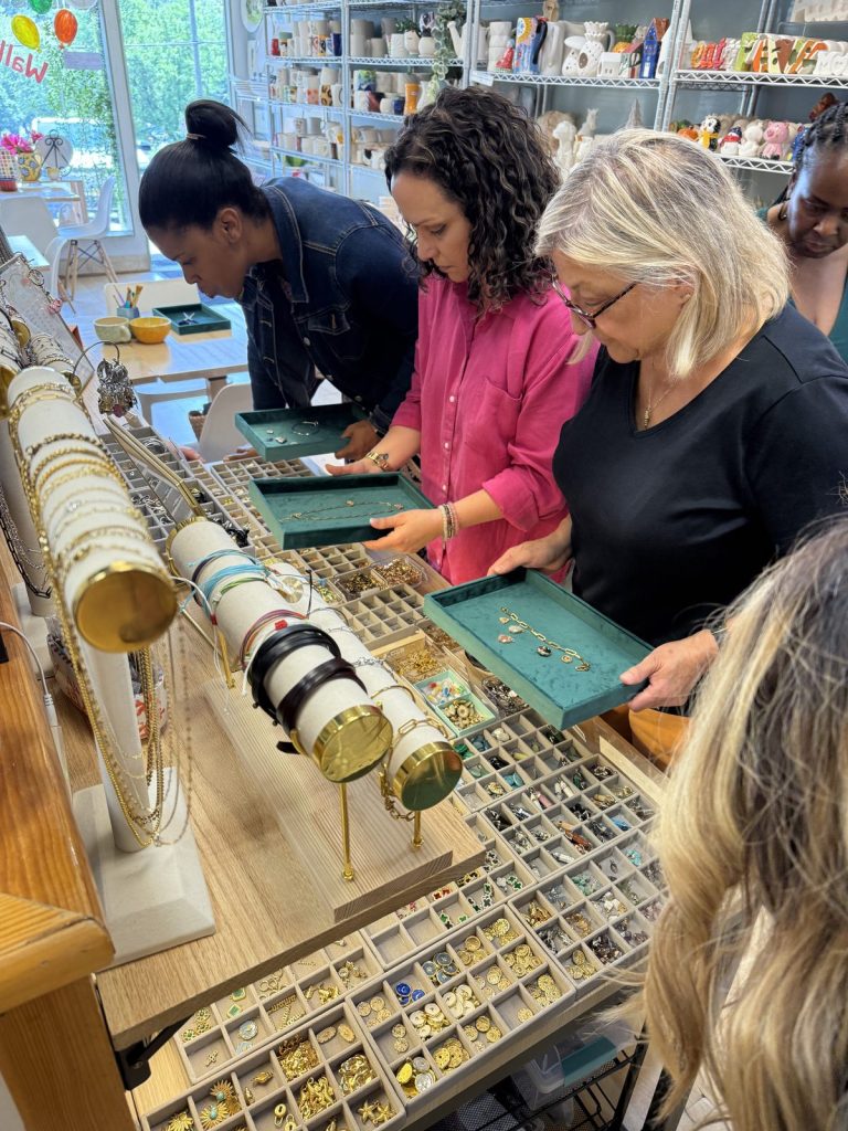 Women choosing charms at the Charm Bar during an adult jewelry party