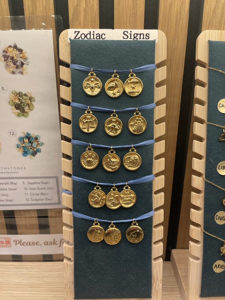 Zodiac sign charms on a display board