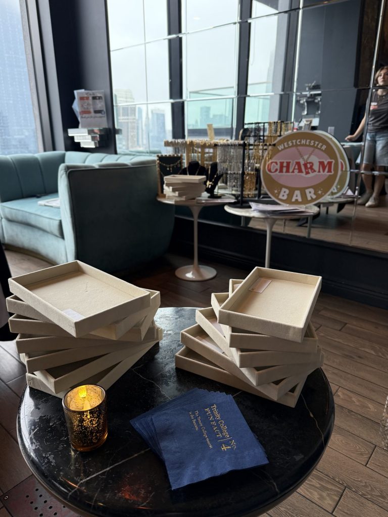 Charm Bar sign and bracelet displays in a high-rise event space