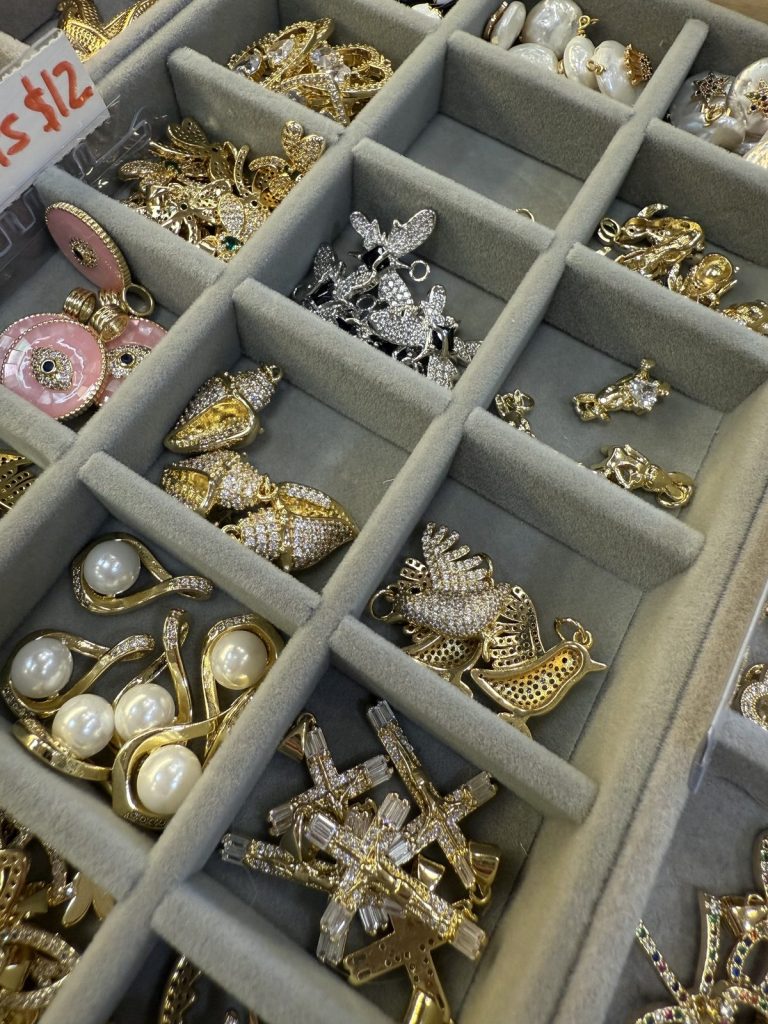 Pearl, cross and bird charms