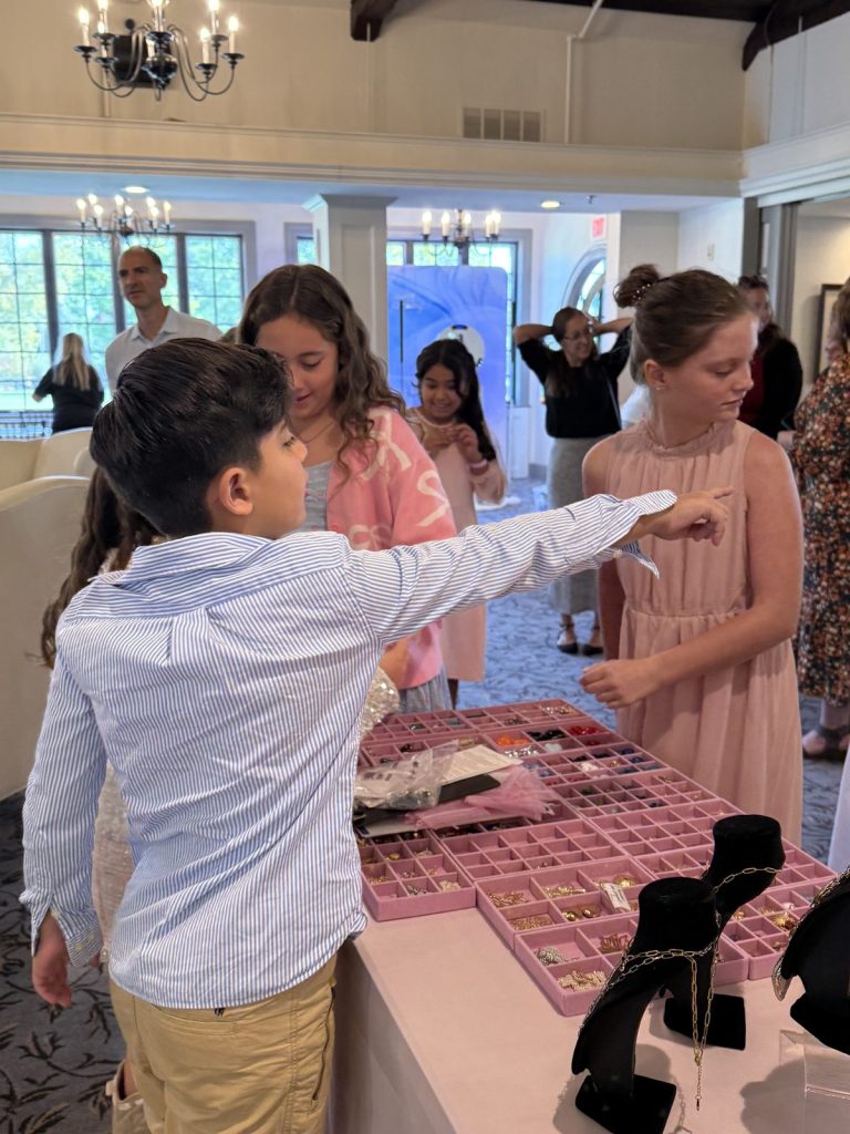 Kids choosing charms at a Mobile Charm Bar at a celebration